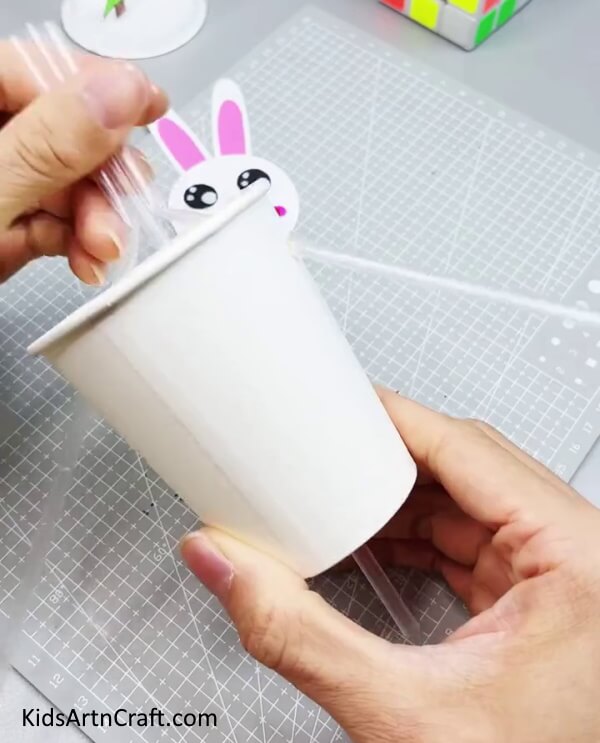 Inserting Straws In Different Holes - Forming a Bunny from Recycled Paper Cups for Children