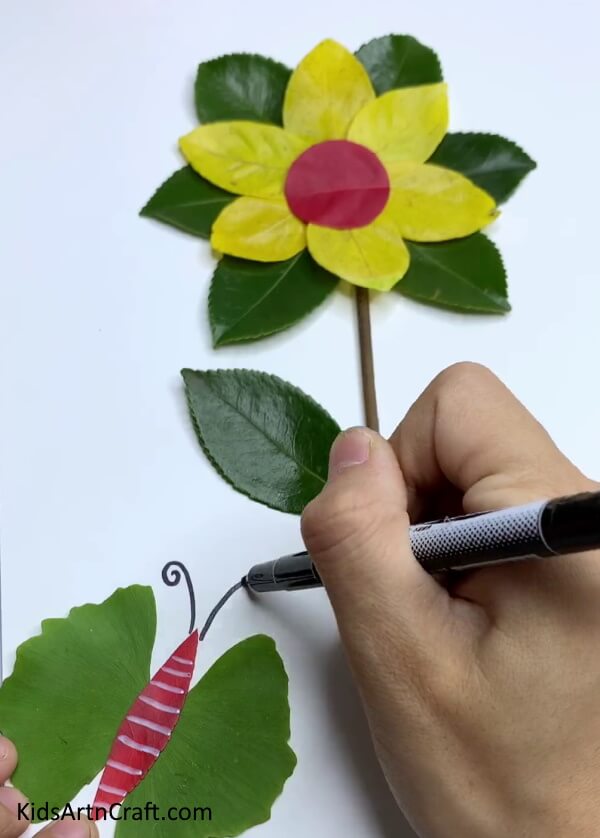 Adding Details- Learn the art of making a flower craft from fresh leaves - a tutorial